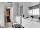 Stylish bathroom showcasing floating double vanity sinks, modern mirror, and open door to custom closet at 3144 Sherwood Oaks Ln, Decatur, GA 30034