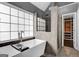 Spa-like bathroom with soaking tub, large window, and walk-in shower, plus an open door to custom closet at 3144 Sherwood Oaks Ln, Decatur, GA 30034