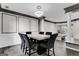 Stylish dining room featuring modern lighting, wainscoting, dark trim, and a marble-top table with seating for six at 3144 Sherwood Oaks Ln, Decatur, GA 30034