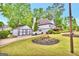 Home with a detached garage and a well maintained lawn and landscaping at 3144 Sherwood Oaks Ln, Decatur, GA 30034