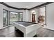 Bright game room with hardwood floors, decorative trim, and large windows, complete with a modern, white pool table at 3144 Sherwood Oaks Ln, Decatur, GA 30034