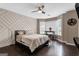 Bright bedroom boasts a decorative accent wall, bay window, and ceiling fan at 3144 Sherwood Oaks Ln, Decatur, GA 30034