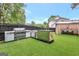 Outdoor kitchen has a built-in grill, modern countertops and an adjacent dining area at 3144 Sherwood Oaks Ln, Decatur, GA 30034