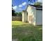 A rear exterior view, with a partial fence, green lawn and mature trees at 466 Joseph E Lowery Nw Blvd, Atlanta, GA 30314