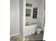 Bathroom needing renovation, featuring a vanity, toilet, and window for ventilation at 466 Joseph E Lowery Nw Blvd, Atlanta, GA 30314