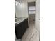 Bathroom featuring a double vanity with marble countertop and modern fixtures with marble tile flooring at 2791 Biscayne Dr, Conyers, GA 30012