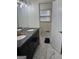 Bathroom featuring a double vanity with marble countertop and modern fixtures with marble tile flooring at 2791 Biscayne Dr, Conyers, GA 30012