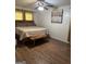 Spacious bedroom with wood floors, a large bed with decorative headboard, a ceiling fan, and natural light at 2791 Biscayne Dr, Conyers, GA 30012