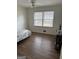 A cozy bedroom with hardwood floors and natural light from a large window at 2791 Biscayne Dr, Conyers, GA 30012