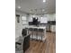 Updated kitchen featuring white cabinetry, stainless steel appliances, and a granite island at 2791 Biscayne Dr, Conyers, GA 30012