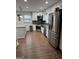 Modern kitchen featuring stainless steel appliances, granite countertops, and sleek white cabinetry at 2791 Biscayne Dr, Conyers, GA 30012