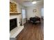 Cozy living room with a fireplace, desk and hardwood floors at 2791 Biscayne Dr, Conyers, GA 30012