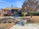Expansive backyard featuring a covered patio, lush landscaping, and brick-paved walkway at 200 Magnolia Ct, Mcdonough, GA 30252