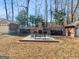 Inviting backyard with brick fireplace, seating area, and sparse lawn at 200 Magnolia Ct, Mcdonough, GA 30252
