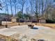 Backyard features a fire pit, patio area, storage buildings, landscaping, and lawn at 200 Magnolia Ct, Mcdonough, GA 30252
