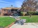 Home exterior with a brick patio, wood deck, lawn, and landscaping at 200 Magnolia Ct, Mcdonough, GA 30252