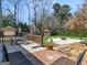 Expansive backyard featuring a brick patio, lawn, fire pit, and seating area for outdoor enjoyment at 200 Magnolia Ct, Mcdonough, GA 30252