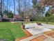 Wide backyard features a fire pit, patio area, storage building, landscaping, and lawn at 200 Magnolia Ct, Mcdonough, GA 30252