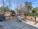 Charming backyard patio area with metal patio furniture, brick fireplace, and garage in a landscaped setting at 200 Magnolia Ct, Mcdonough, GA 30252