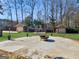 Green backyard features a fire pit, patio area, storage buildings, landscaping, and lawn at 200 Magnolia Ct, Mcdonough, GA 30252