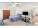 Well-lit bedroom with a ceiling fan, TV, and ample storage space at 200 Magnolia Ct, Mcdonough, GA 30252