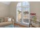 Bedroom featuring a large window with shutters, cozy seating, and a popcorn machine at 200 Magnolia Ct, Mcdonough, GA 30252