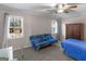 Well-lit bedroom with twin windows and a classic armoire at 200 Magnolia Ct, Mcdonough, GA 30252