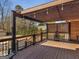 Wood deck offers outdoor relaxation with dark wood railings and a latticed shade structure at 200 Magnolia Ct, Mcdonough, GA 30252