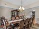 Elegant dining room showcasing a large table and ornate china cabinet at 200 Magnolia Ct, Mcdonough, GA 30252
