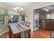 Sunlit dining room featuring a large window, hardwood floors, and a granite-topped table at 200 Magnolia Ct, Mcdonough, GA 30252