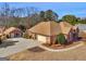 Beautiful brick home with a two-car garage, an outbuilding and pristine landscaping at 200 Magnolia Ct, Mcdonough, GA 30252