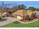 Beautiful brick home with a two-car garage, an outbuilding and pristine landscaping at 200 Magnolia Ct, Mcdonough, GA 30252