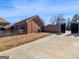 Brick home featuring an attached garage, brick wall, and a paved driveway at 200 Magnolia Ct, Mcdonough, GA 30252