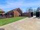 Brick home featuring an attached garage, brick wall, and a paved driveway at 200 Magnolia Ct, Mcdonough, GA 30252