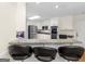 Breakfast bar with granite countertop and bar stools overlooking a bright kitchen with modern appliances at 200 Magnolia Ct, Mcdonough, GA 30252