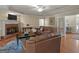 Cozy living room features a fireplace, hardwood floors, and comfortable leather seating with plenty of natural light at 200 Magnolia Ct, Mcdonough, GA 30252