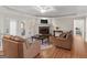 Spacious living room with hardwood floors, a cozy fireplace, and comfortable leather furniture at 200 Magnolia Ct, Mcdonough, GA 30252