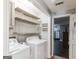 Functional laundry room with shelving and modern washer and dryer at 100 Williams Blf, Mcdonough, GA 30252