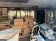Damaged living room features debris and exposed walls at 65 Little John Trl, Hampton, GA 30228