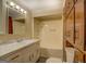 Bathroom features a shower, vanity, marble countertop and matching cabinets and toilet at 34 Ivy St, Porterdale, GA 30014