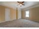 Comfortable bedroom featuring neutral walls, carpeted flooring, a window, and ample closet space at 34 Ivy St, Porterdale, GA 30014