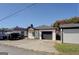 Charming single-story home with a garage and freshly painted white siding and a paved driveway at 34 Ivy St, Porterdale, GA 30014