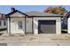 Charming home featuring a garage and covered porch area at 34 Ivy St, Porterdale, GA 30014