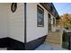 Stylish home exterior featuring white horizontal siding with black trim, a small porch, and a well-maintained foundation at 34 Ivy St, Porterdale, GA 30014