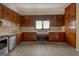 Well lit kitchen with stainless steel appliances, tile countertops, and vintage wood cabinetry at 34 Ivy St, Porterdale, GA 30014