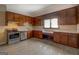Spacious kitchen with stainless steel appliances and ample vintage wood cabinetry at 34 Ivy St, Porterdale, GA 30014