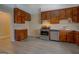Kitchen featuring stainless steel oven, dishwasher, tiled counters, wood cabinets and plank floors at 34 Ivy St, Porterdale, GA 30014