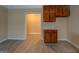 Kitchenette with built-in cabinets and tile countertops, open to another room at 34 Ivy St, Porterdale, GA 30014