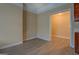 Open concept with vinyl flooring leading to another room with vintage wood cabinetry at 34 Ivy St, Porterdale, GA 30014
