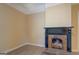 Charming living area highlighting light wood-look flooring and a classic fireplace with a stone surround at 34 Ivy St, Porterdale, GA 30014